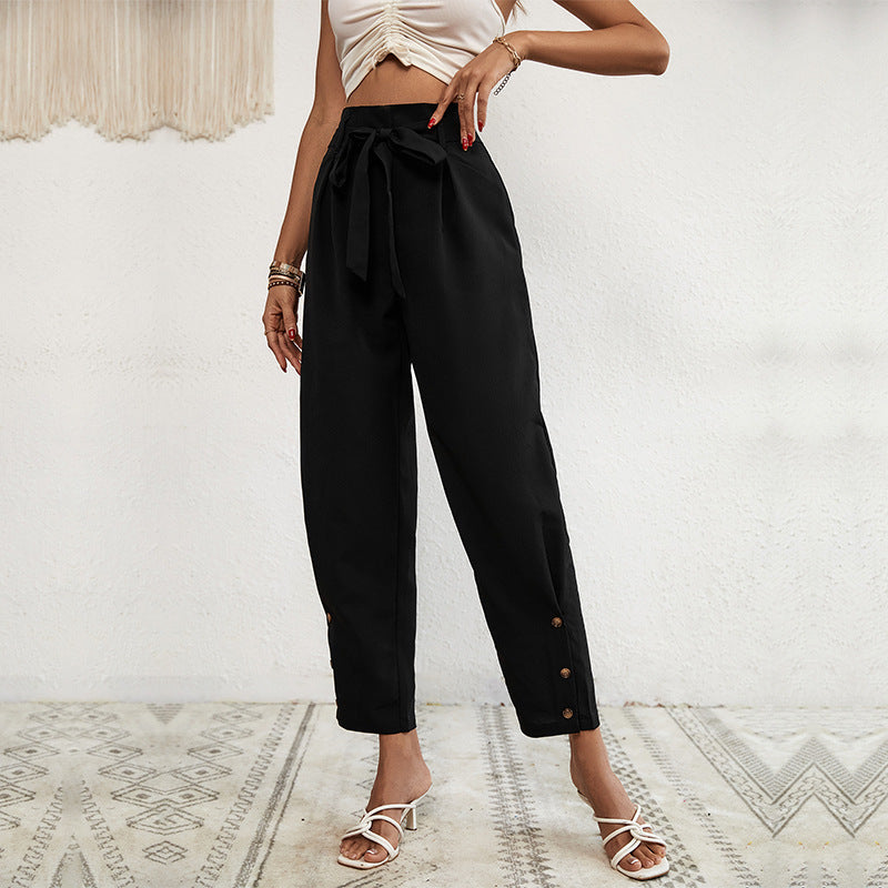 Ladies high-waisted paperbag trousers with tie belt, tapered leg and decorative button placket Chichicherry