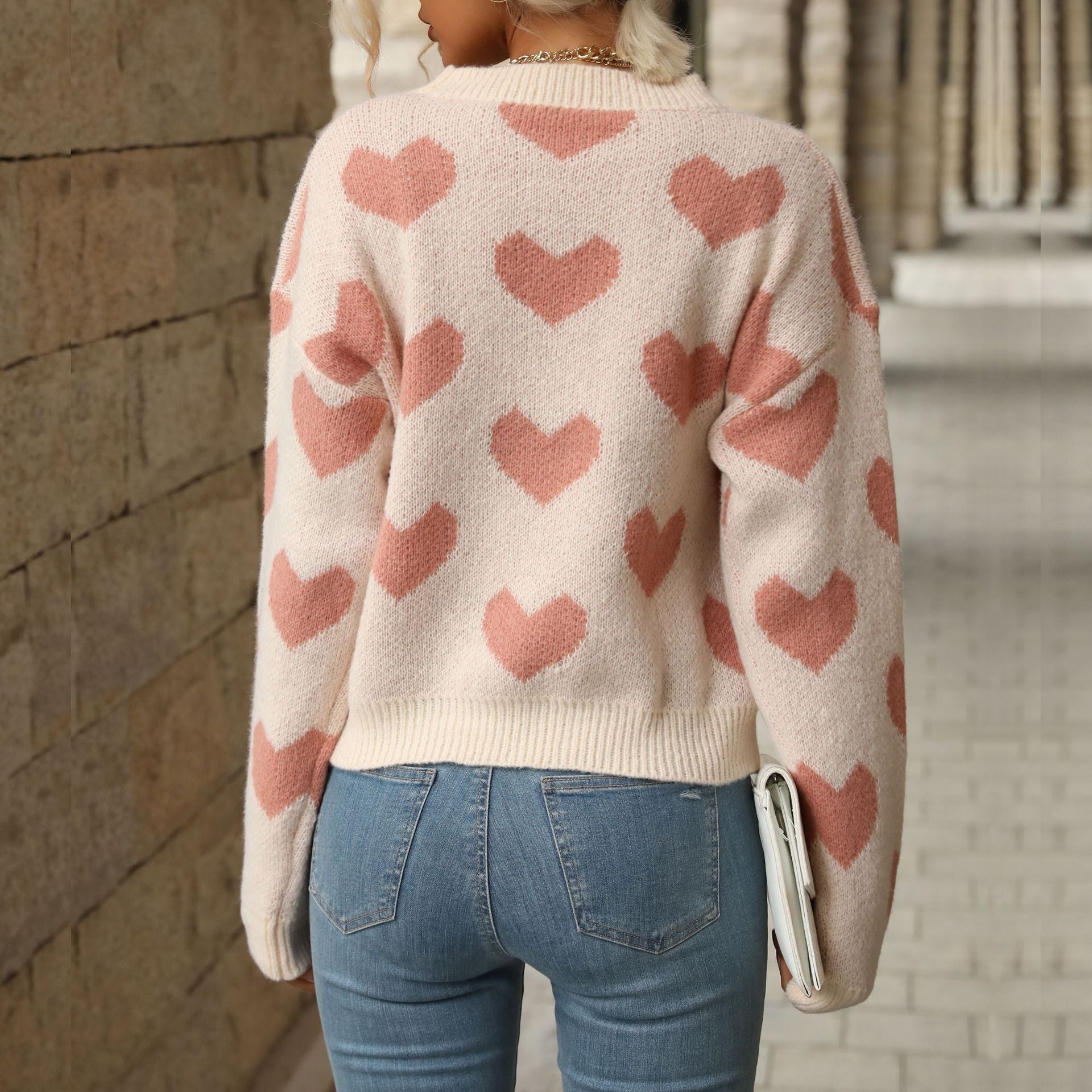 Women's sweater with heart all-over pattern, round neckline and relaxed fit.