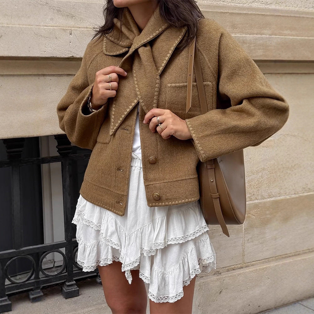 Women's short jacket made of wool blend with a suggested shawl collar, decorative seams, and boxy cropped cut Chichicherry