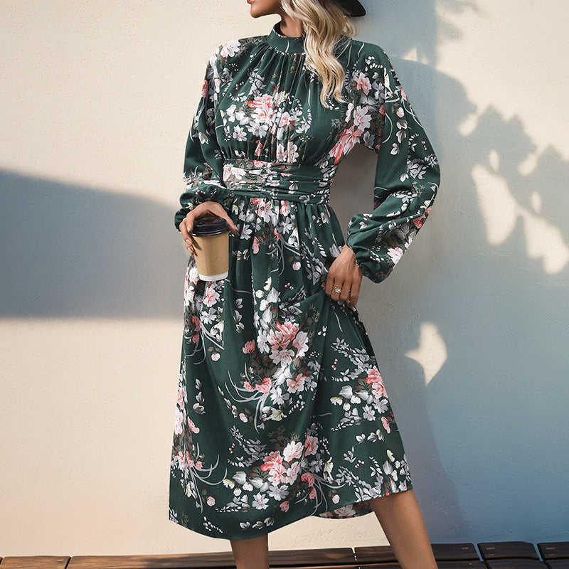 Women's midi dress with floral all-over print, stand collar and draped waist belt.