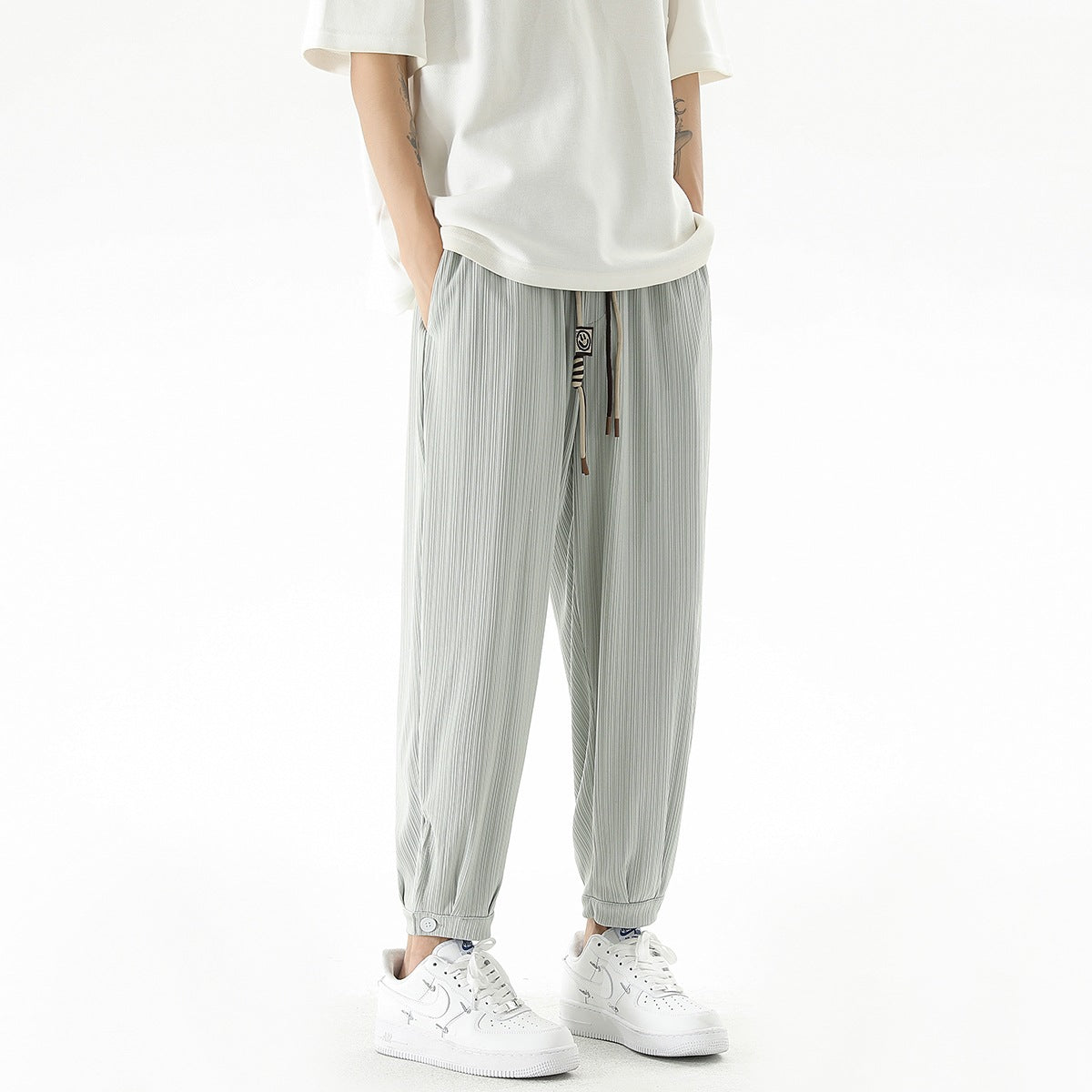 Men's loose-fitting leisure pants with drawstring, fine ribbed structure, and buttoned cuffs Chichicherry