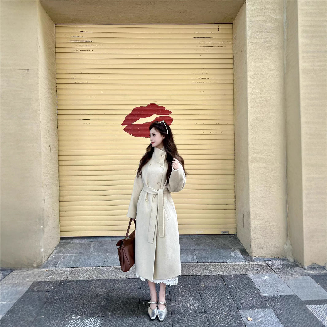 Women’s wool coat with double-breasted button placket, waist belt, and stand-up collar Chichicherry