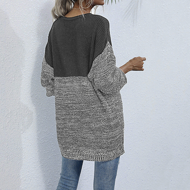 Women's oversized knitted sweater with color block look, round neckline, and mottled textured knit.