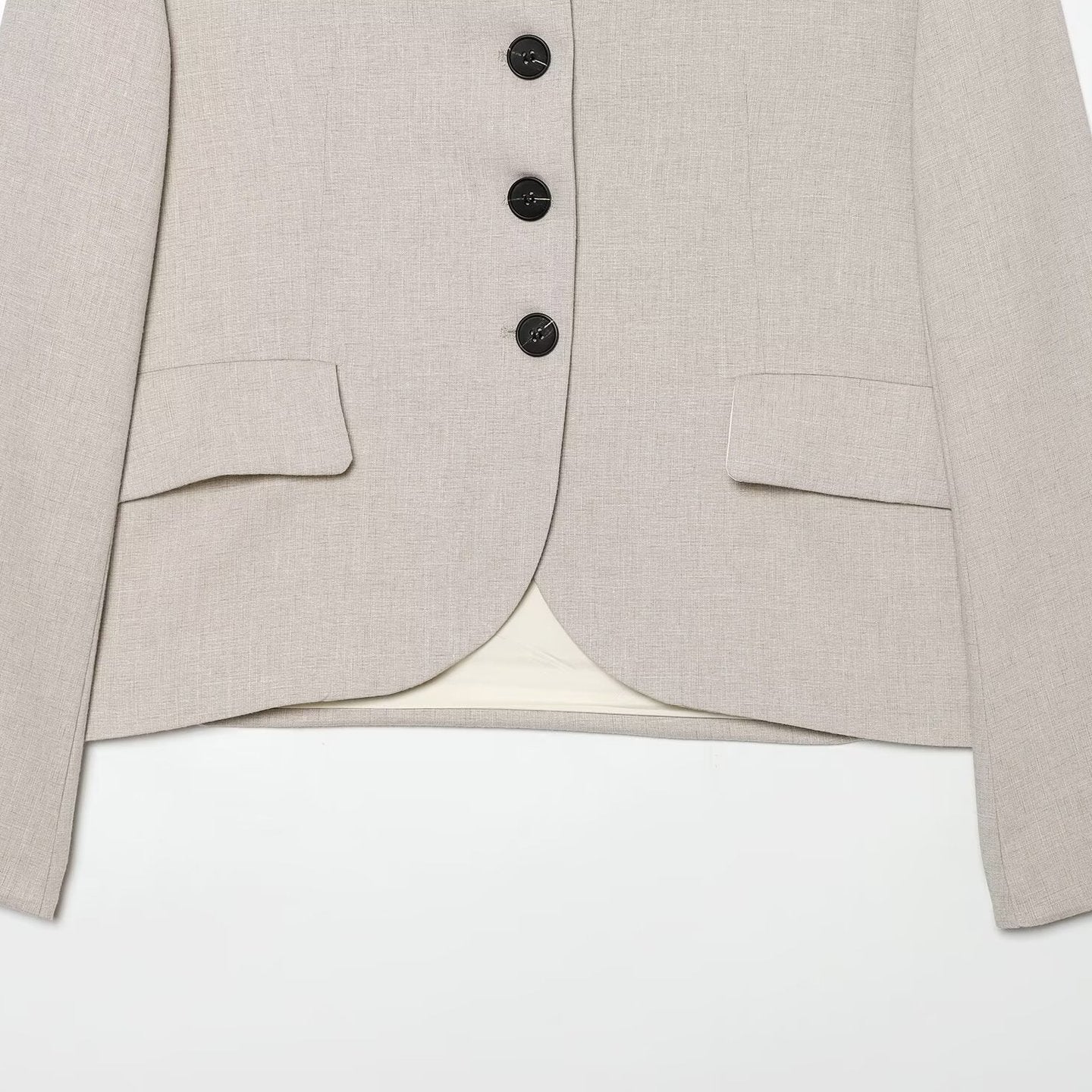 Women's short blazer with minimalist lines, rounded hem, and flap pockets Chichicherry