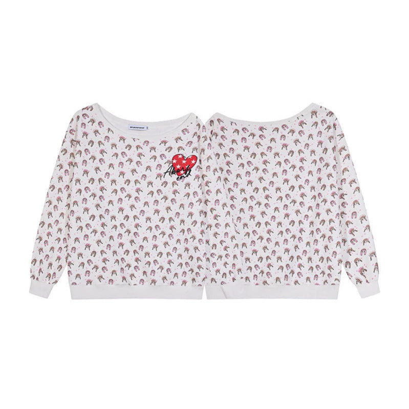 Women's sweatshirt with allover cartoon print, wide round neckline and heart patch.