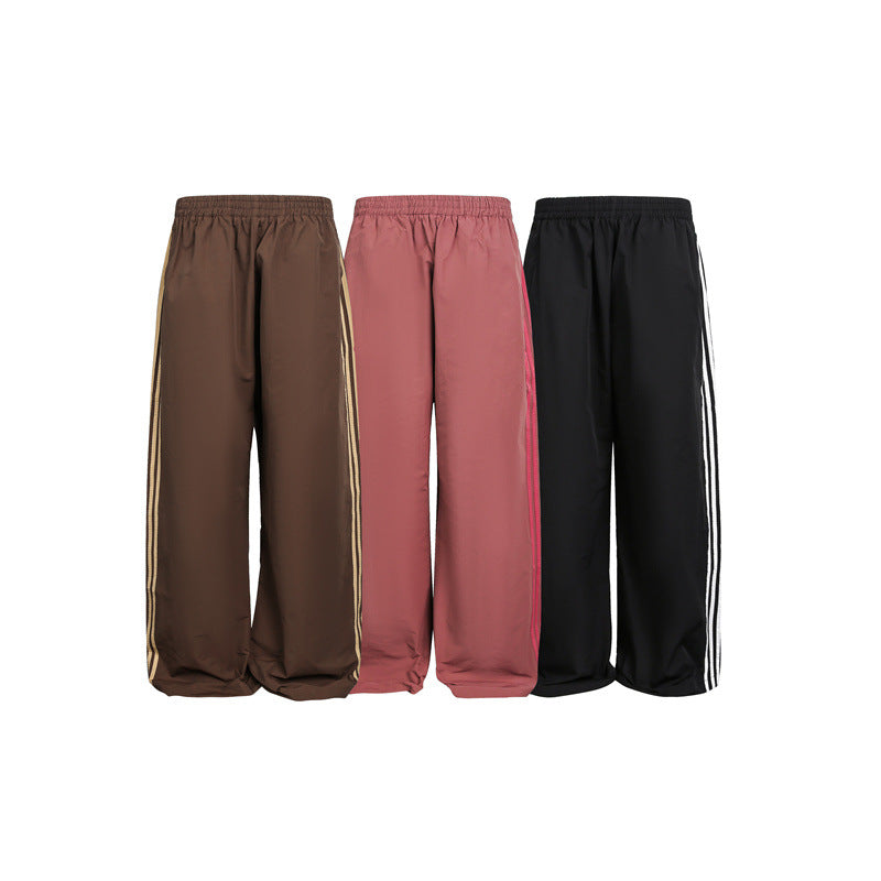 Women's wide satin training pants with elastic waistband and side contrast stripes Chichicherry