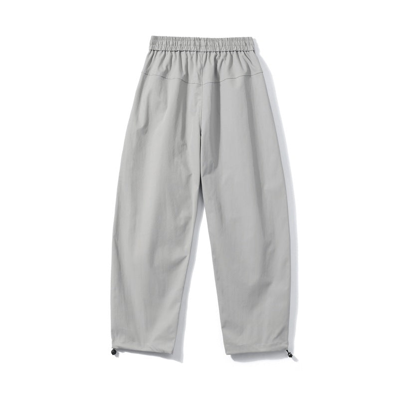 Men's utility cargo pants with elastic waistband, zip pocket, and adjustable hem.