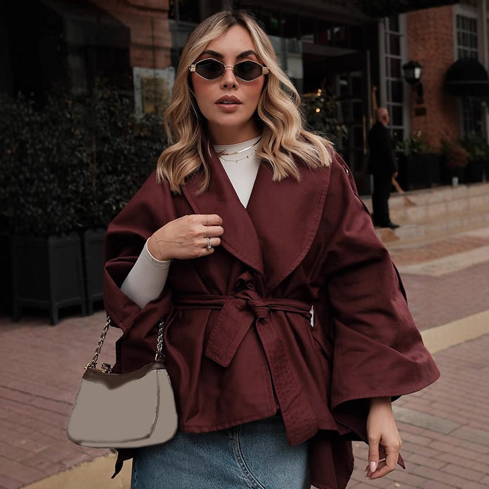Women's short trench-style jacket with belted waist, oversized sleeves, and boxy cropped silhouette Chichicherry