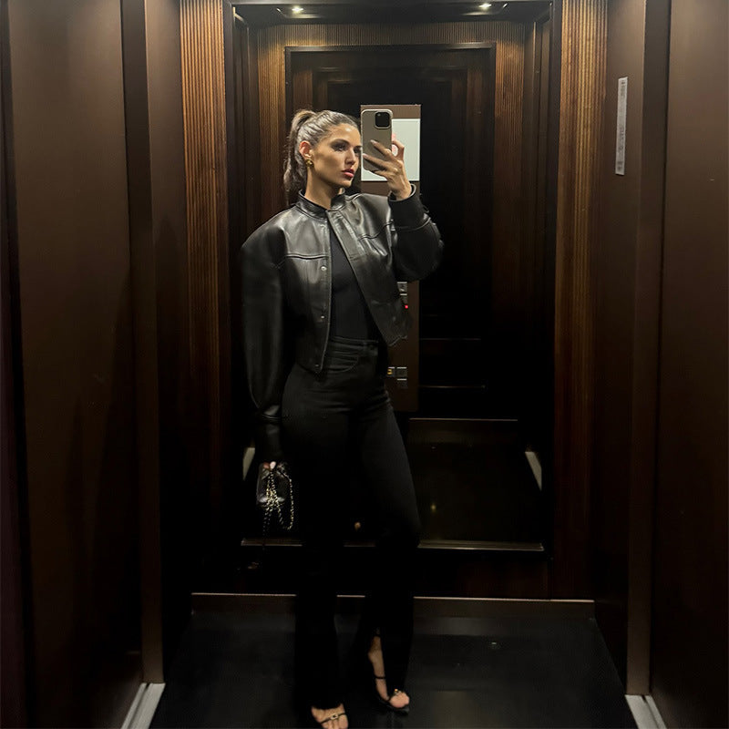 Women's short jacket made of vegan smooth leather with prominent shoulder pads and concealed snap button placket Chichicherry