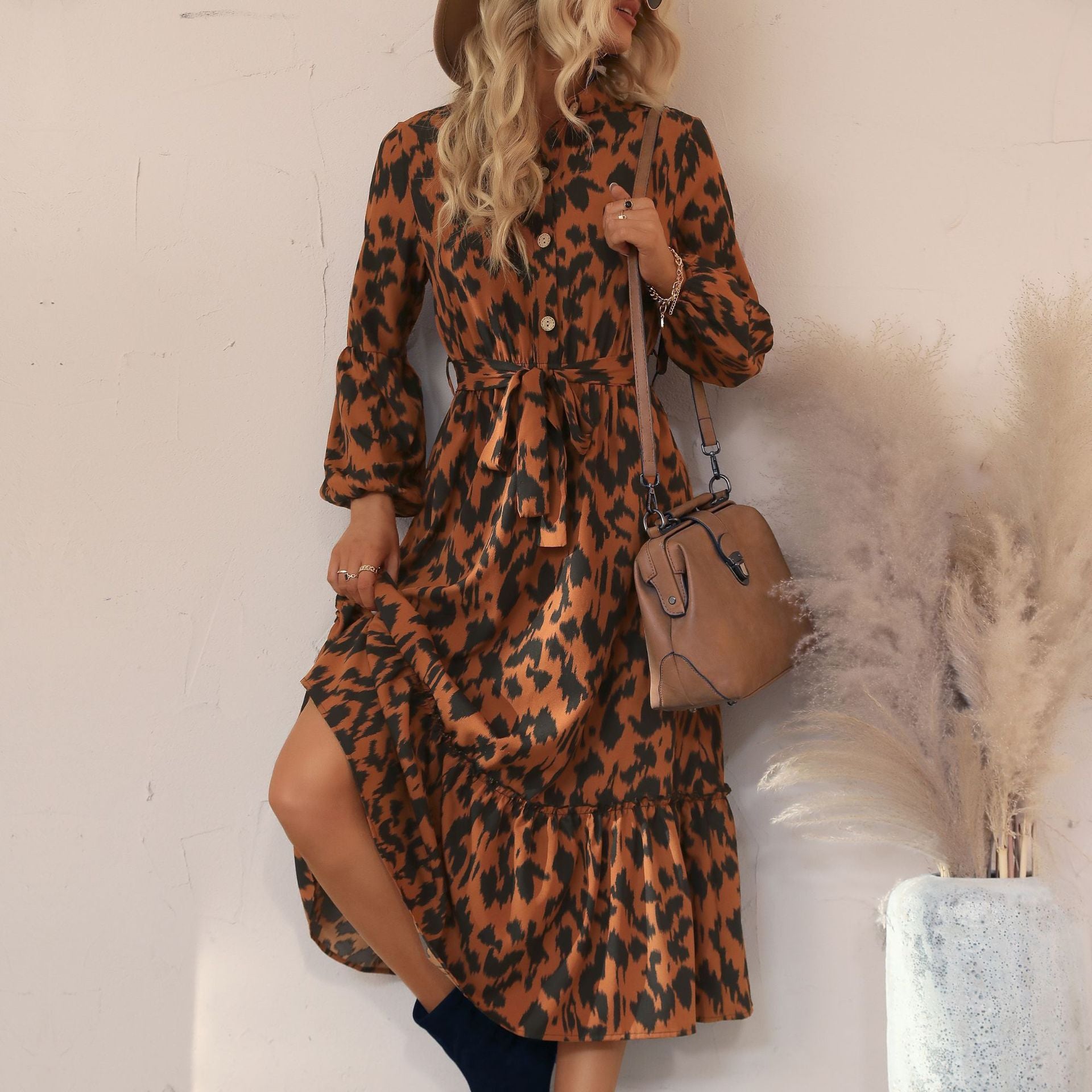 Women's viscose midi dress with leopard print, concealed button placket, waistband, and tiered ruffles.