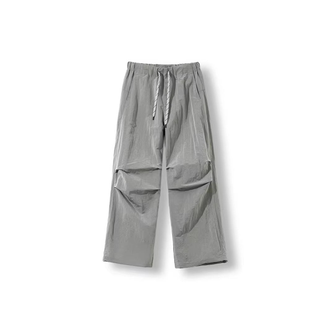 Men's loose-fitting nylon track pants with drawstring, patch pockets, and straight wide-leg fit Chichicherry