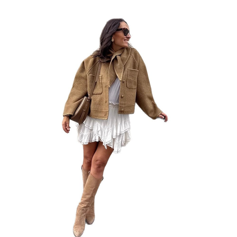 Women's short jacket made of wool blend with a suggested shawl collar, decorative seams, and boxy cropped cut Chichicherry