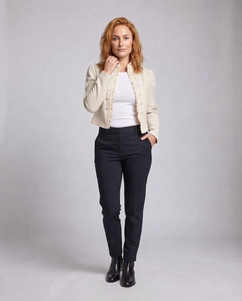 Women's short fitted jacket with ruffled hem, stand-up collar and decorative pleats.
