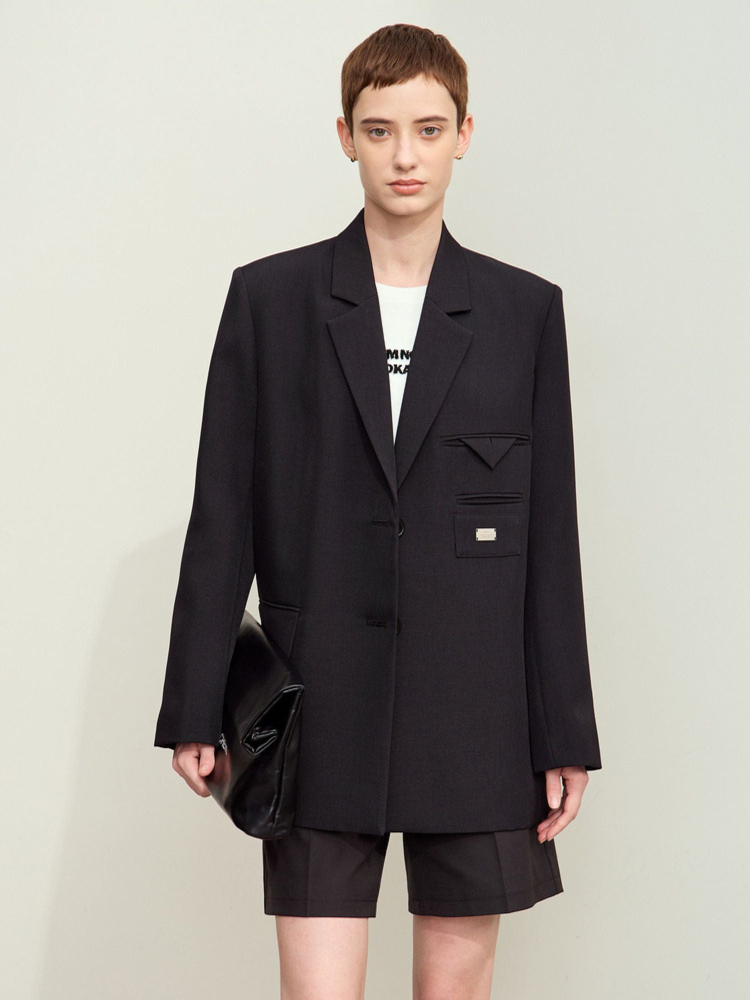 Straight-on view of black tailored double‑breasted blazer on model