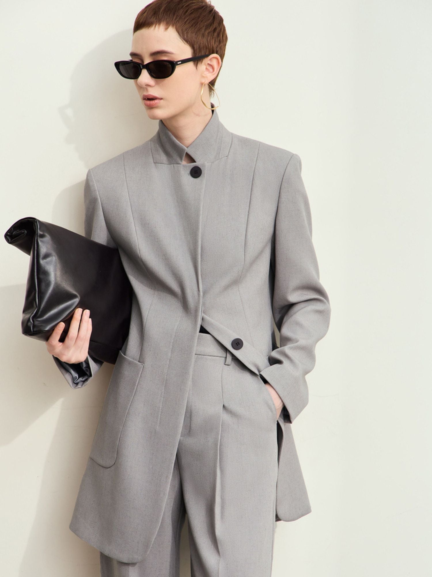 Detail of blazer's structured shoulder and mandarin-style collar seam