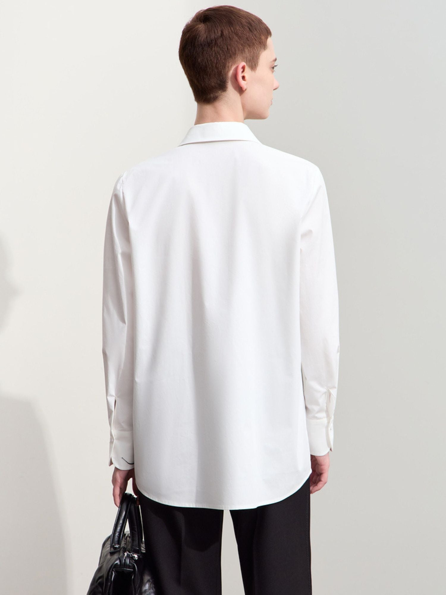 Rear view of white button-down shirt with clean back and relaxed fit