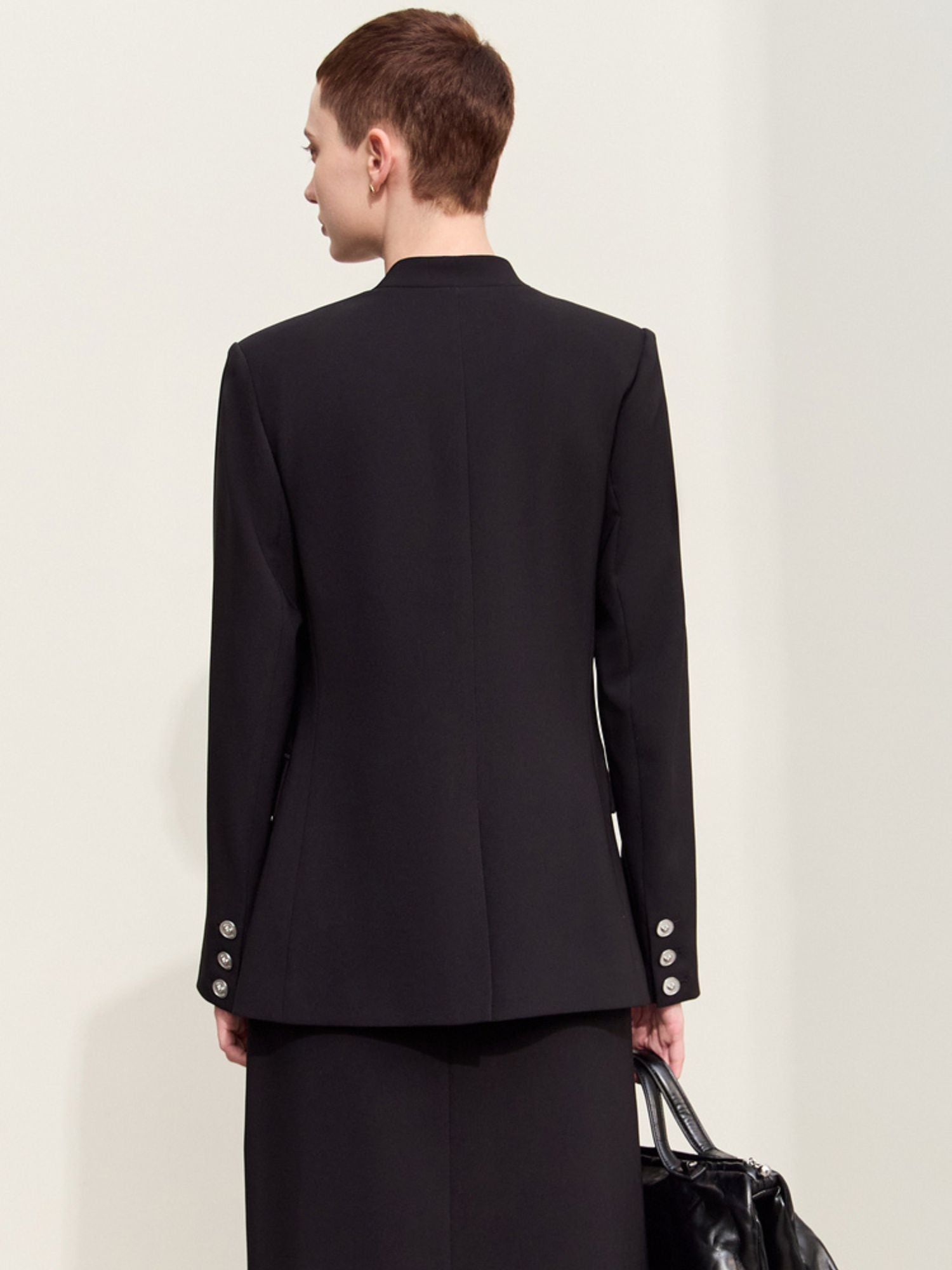 Back view of the black blazer showing a clean seam and tailored cut