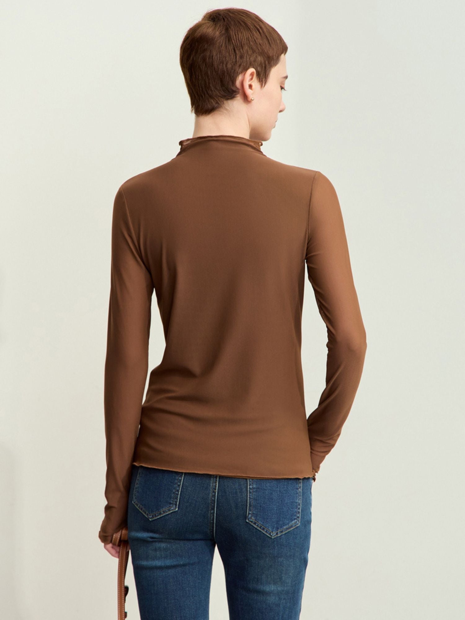 Back view of brown blouse detailing back drape and fit