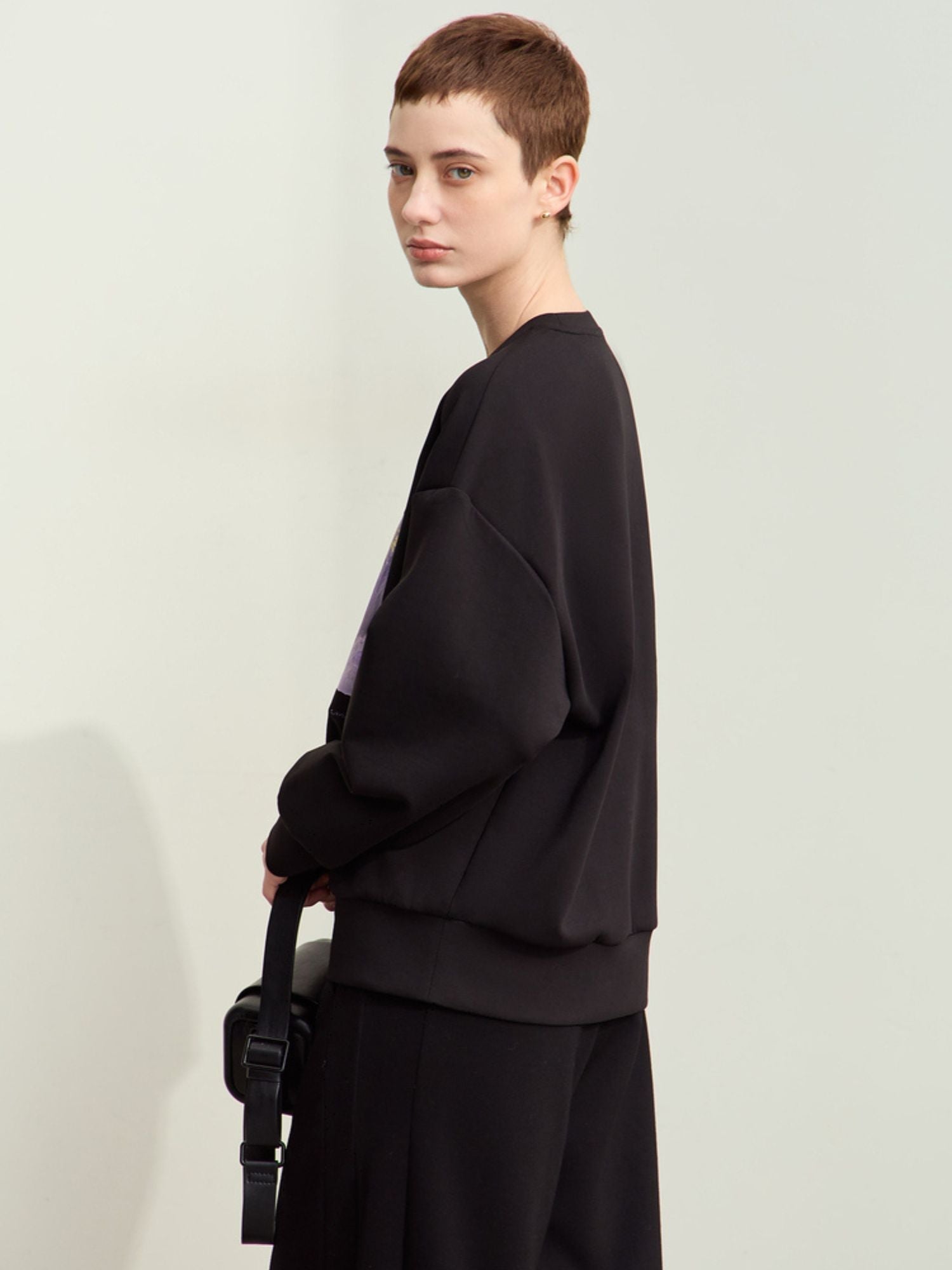 Three-quarter back view of black sweatshirt featuring