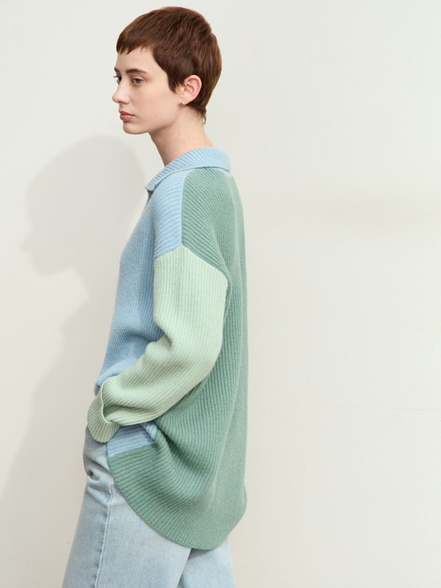 Rear three-quarter view of sweater showing loose fit and mint green back panel