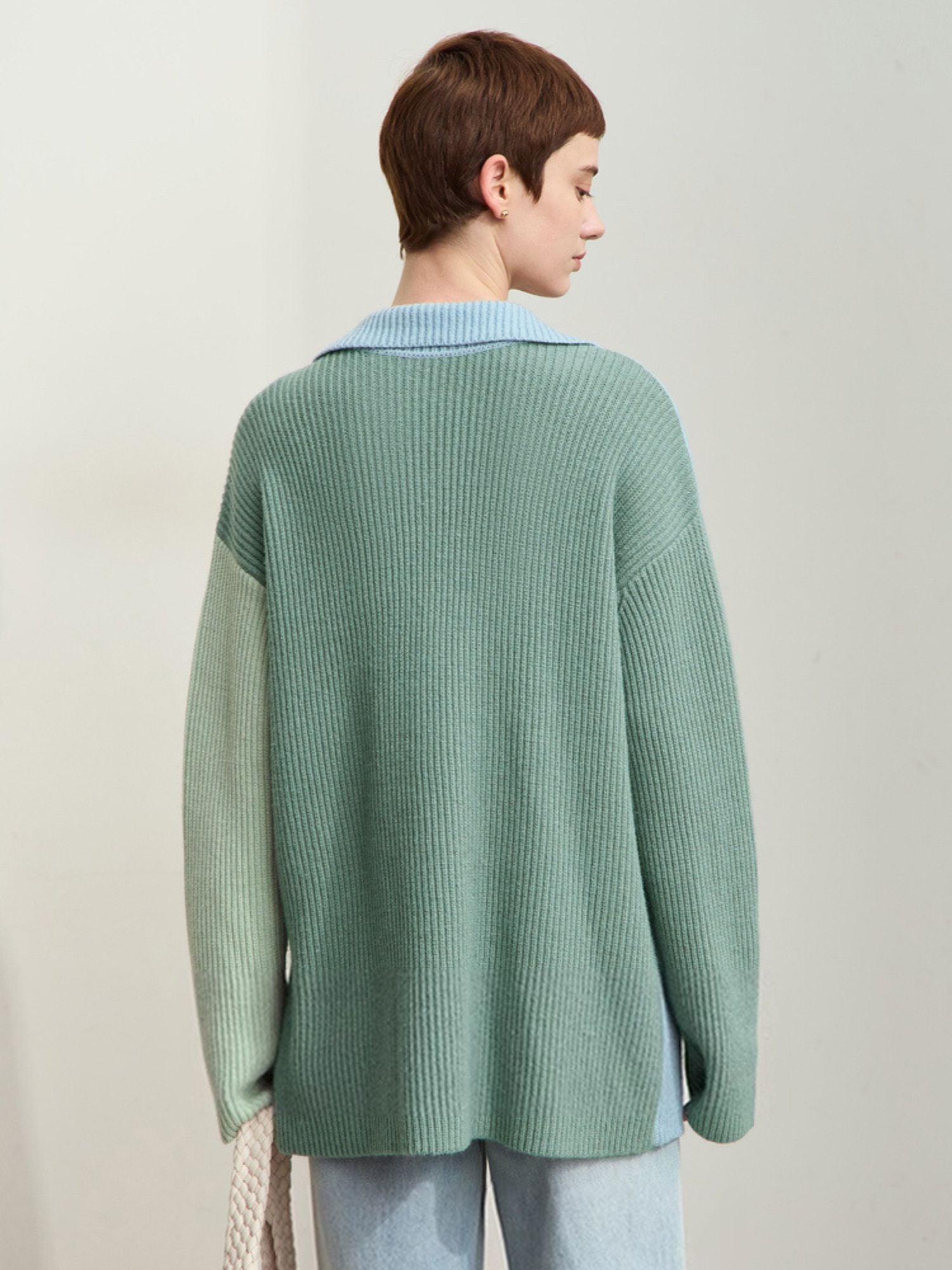 Rear view of sweater showing loose fit and mint green back panel