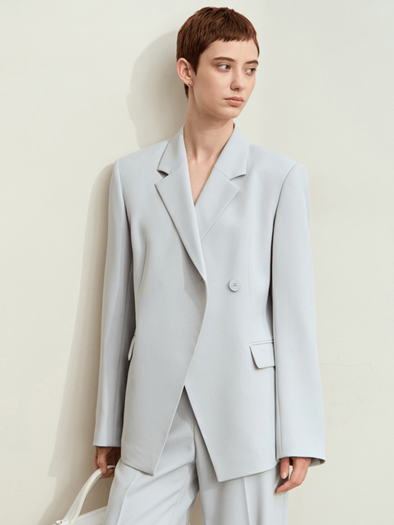Front view of light‑blue tailored blazer with structured shoulders