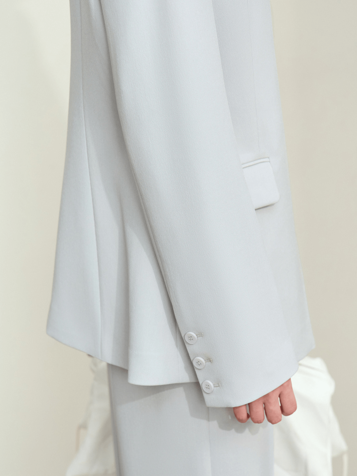 Side view of light‑blue blazer emphasizing clean silhouette