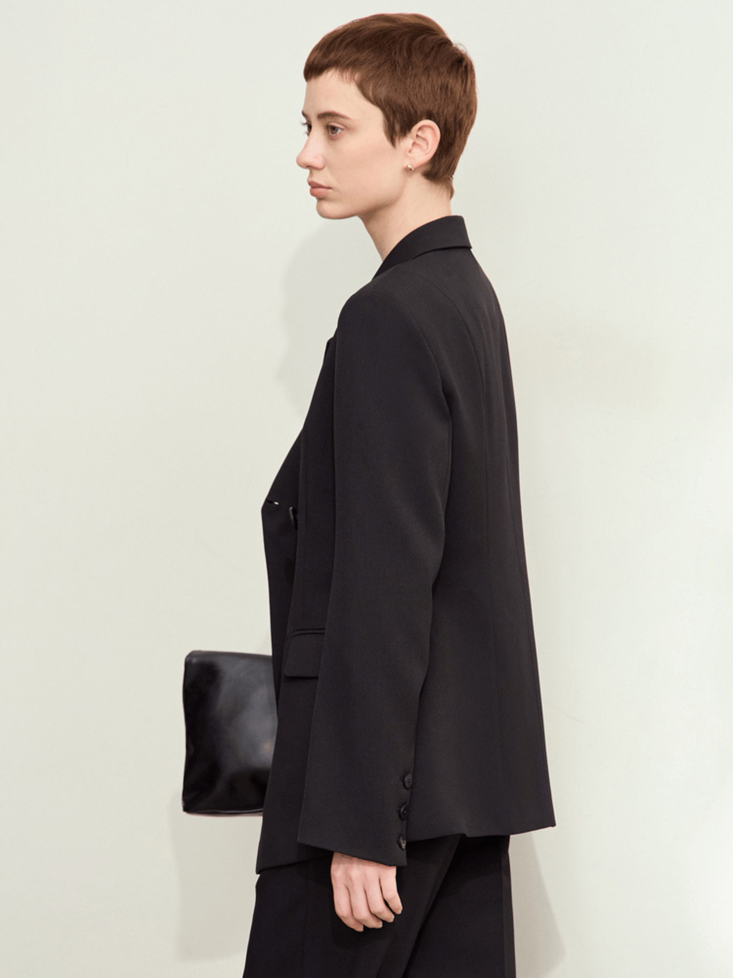Side view of black blazer emphasizing clean silhouette