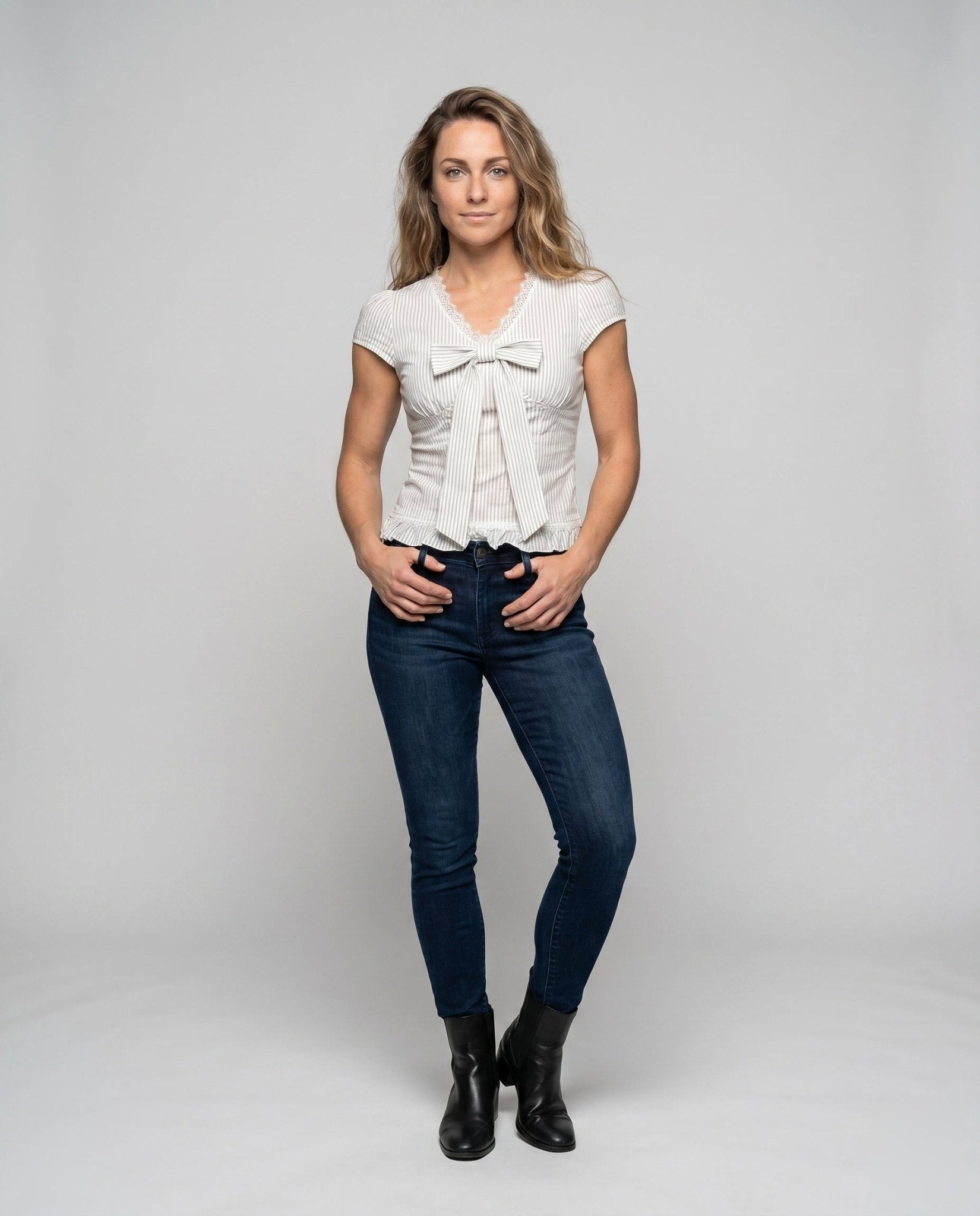 Women’s blouse shirt with playful bow design and ruffled hem - Chichicherry