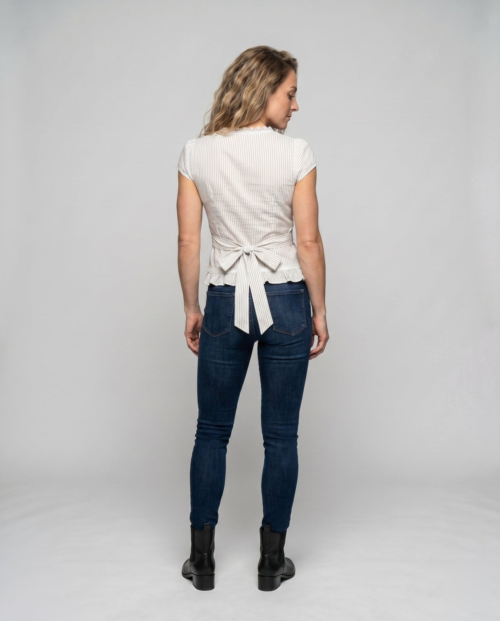 Women’s blouse shirt with playful bow design and ruffled hem - Chichicherry