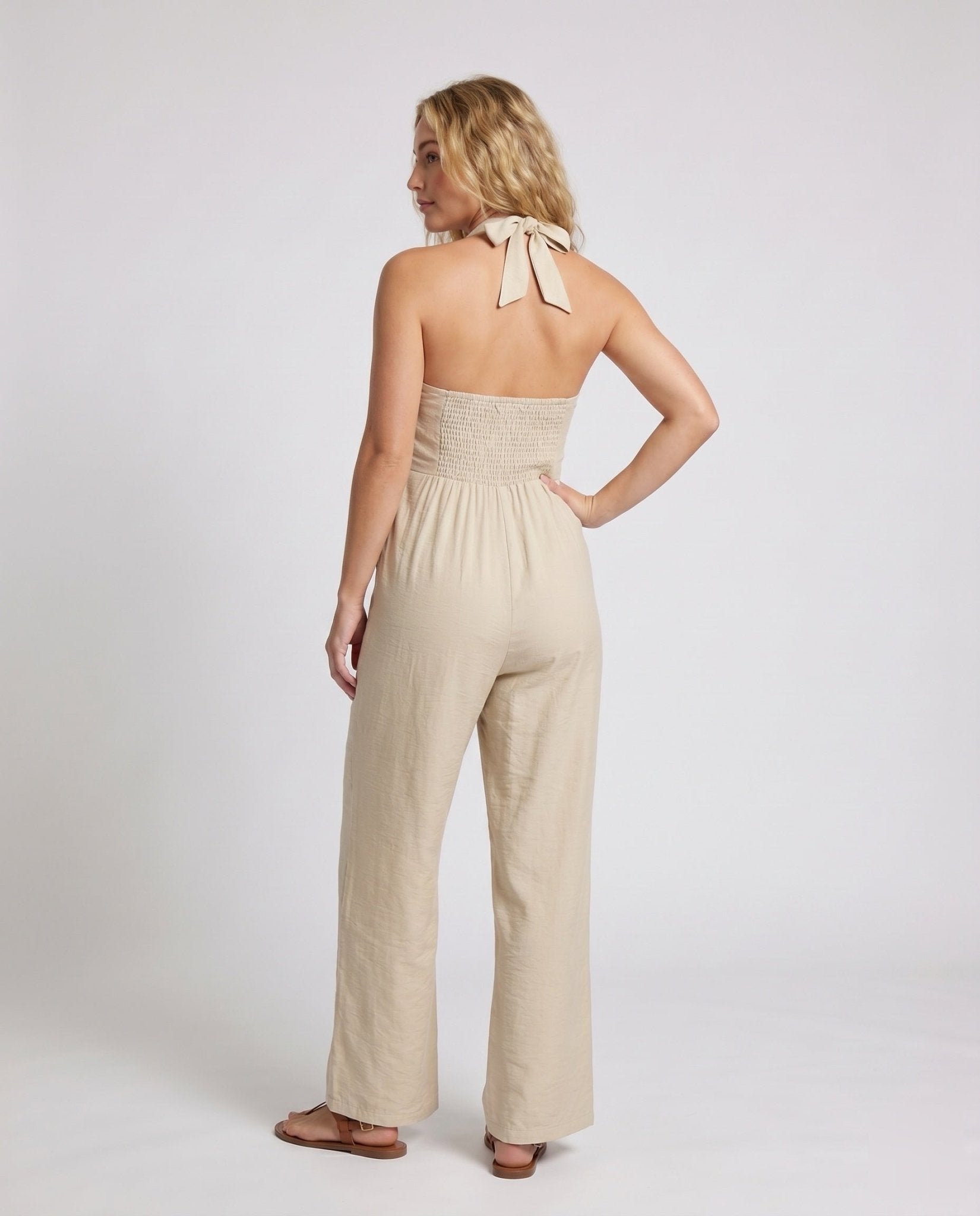 Women's jumpsuit with deep V-neckline and elegant button details - Chichicherry