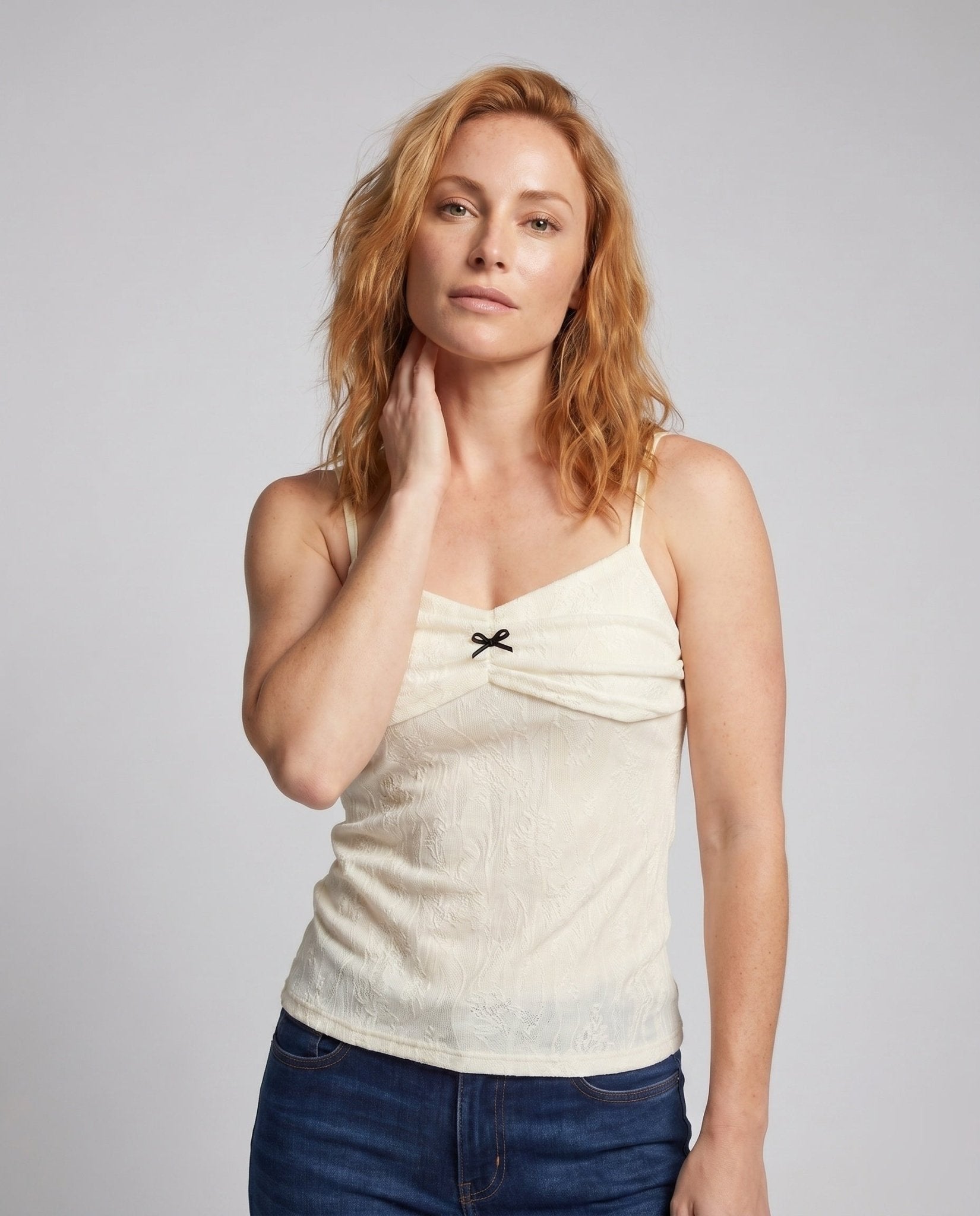 Women's tank top with decorative ruffle design and feminine bow accent - Chichicherry