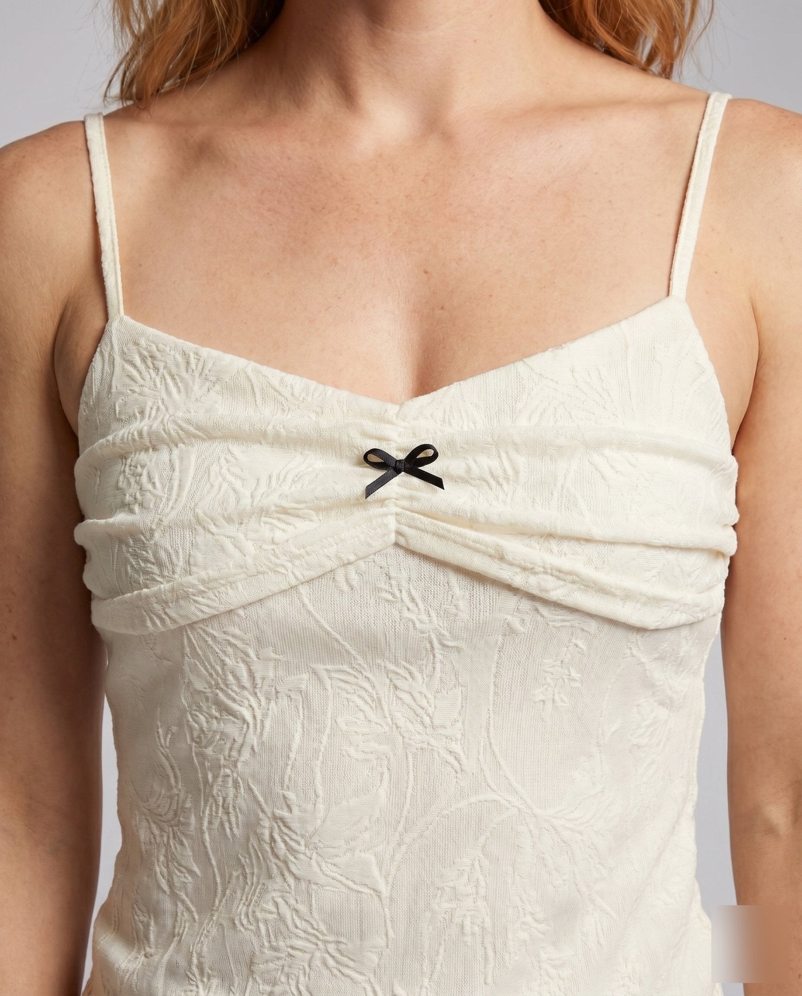 Women's tank top with decorative ruffle design and feminine bow accent - Chichicherry